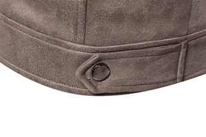 Macro view of dark brown suede jacket hem with metal button and CLASSIC engraving