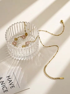 Detailed view of 18K gold plated daisy chain necklace with sparkling crystals in sunlight