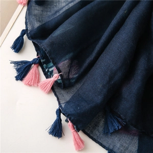 Detail of navy blue cotton linen scarf with soft pink fringe and woven fabric texture