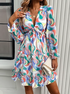 Detail shot of the elegant V-neck and colorful wave print on this long sleeve dress