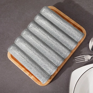 Pack of six silver wire dishcloths for kitchen cleaning on a wooden tray
