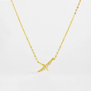 Close-up of golden S925 sterling silver necklace with a sparkling X-shaped diamond pendant