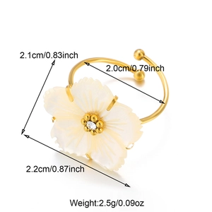 Detail shot of 18k gold butterfly ring with carved shell flower and cz center measurements