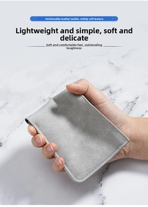 Close-up of slim grey wallet showing soft matte leather texture and fine stitching detail