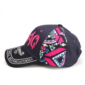 Side view of baseball cap featuring pink AG letter embroidery and colorful geometric patterns