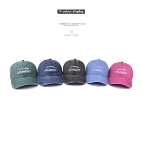 Close-up of vintage washed baseball caps in five colors with Los Angeles embroidery