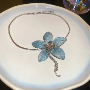 Blue fabric flower tassel necklace with silver snake chain and glitter petals