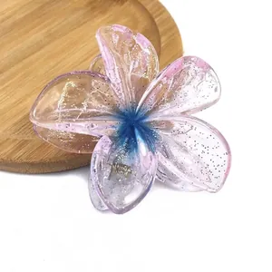 Detail of gradient resin flower hair claw with glitter and sturdy metal spring clip