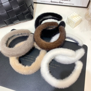 Top view of plush faux fur headbands in black, brown, grey, beige and white colors