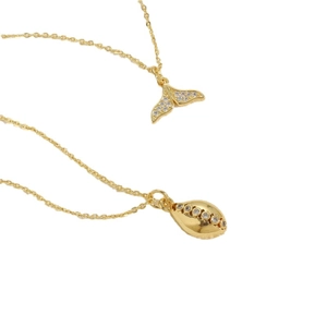 Gold fishtail and sunburst pendant necklaces with cubic zirconia on white background