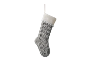 Detail of grey knitted Christmas stocking with white folded cuff and hanging loop