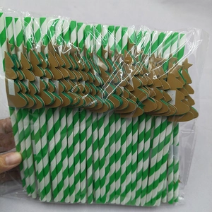 Close-up of green and white striped paper straws with 3D honeycomb Christmas tree decor