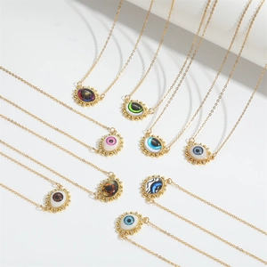 Detail view of colorful Devil's Eye pendant necklaces with gold plated sunflower frames
