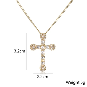 Detail shot of a gold cross pendant showing dimensions 3.2cm x 2.2cm and 5g weight