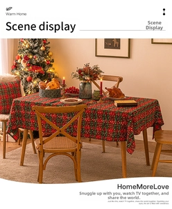 Detail of red and green plaid Christmas tablecloth with snowflake print for festive dining