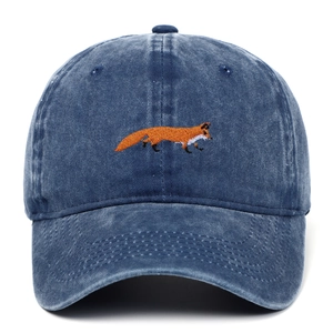 Close-up of orange fox embroidery on vintage washed dark blue denim baseball cap