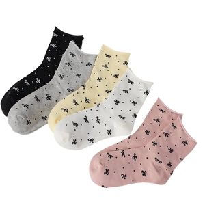 Five pairs of cotton crew socks with polka dots and bow patterns in assorted colors