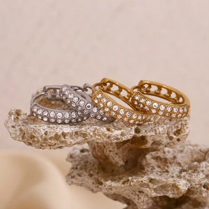 Detailed close-up of double-row pavé heart hoop earrings on natural stone