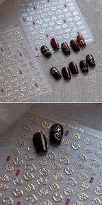 Macro detail of M-881 golden embossed cloud nail stickers on deep red nails