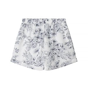Détail du short blanc style lin avec imprimé floral gris et taille élastique