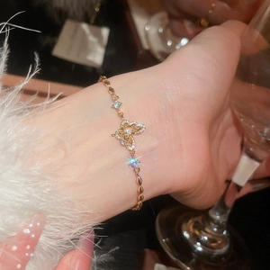 Close-up of a luxury 18k gold-plated butterfly bracelet with sparkling zircon accents