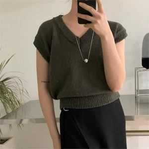 Detail of grey V-neck knitted short sleeve top with slim fit and wide ribbed hem finish