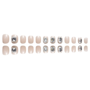 Short square press-on nails in nude pink with luxury rhinestones and glossy finish