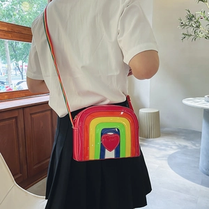 Detailed back view of a crossbody bag with rainbow stripes, heart icon, and wide canvas strap