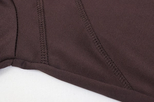 Close-up of high-quality stitching and elastic fabric on brown yoga tracksuit set