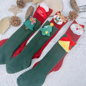 Christmas themed children knitted socks with festive 3D plush deer and Santa decorations
