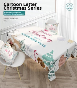 Detail of waterproof cotton linen tablecloth with Merry Christmas text and reindeer motifs