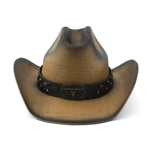 Detail of western straw hat featuring a bull skull buckle and studded leather band