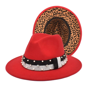 Detail view of red fedora hat featuring leopard print lining and pearl rhinestone band