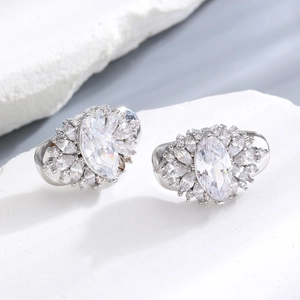 Macro detail of silver tone flower earrings with sparkling marquise cut zircon stones