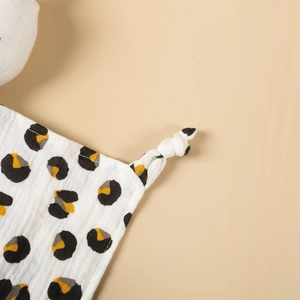 Detail of leopard print cotton gauze baby security blanket with stitched edges and knots