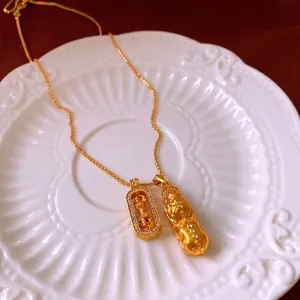 Golden necklace featuring PiXiu and Vajra pendants with sparkling cubic zirconia accents