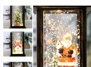 Macro shot of retro Christmas lantern featuring Santa and glowing glitter snow effect