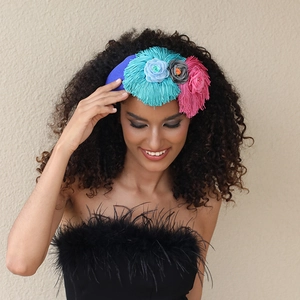 Close-up of blue handmade fabric headband with floral fringe and bohemian details