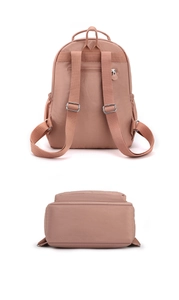 Detailed back view of pink nylon backpack showing shoulder straps and hidden zip pocket