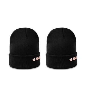 Classic black knitted cuffed beanie hat with elegant pink floral button decorations