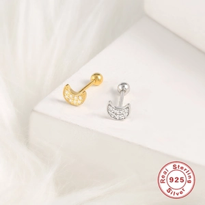 Detail of gold and silver moon earrings in 925 sterling silver on white background