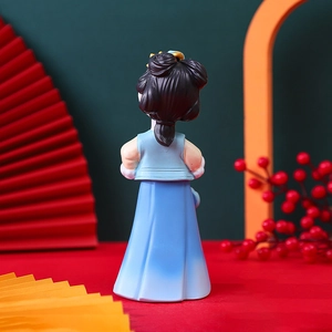 Back view of a Chinese Hanfu doll ornament with blue ancient dress and festive decor