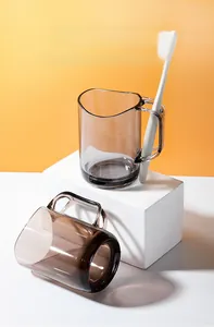 Detail of grey translucent mouthwash cup with integrated toothbrush holder slot