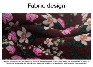 Macro detail of dark red floral fabric with washing instructions and texture