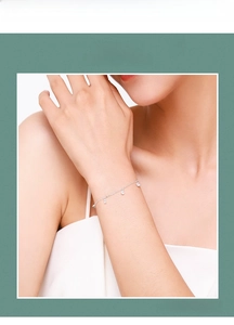 Close-up of s925 silver bracelet featuring five sparkling cubic zirconia round pendants