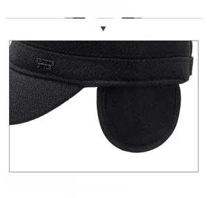 Detail view of winter men's wool flat cap with sports style logo and ear protection