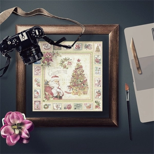 Flat lay of vintage Christmas scrapbook paper with Santa and retro stamps on leather