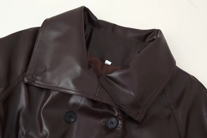 Detailaufnahme des Revers der braunen PU-Lederjacke mit präzisen Nähten und schwarzen Knöpfen