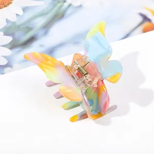 Macro detail of butterfly hair claw clip with colorful acetate texture and spring mechanism