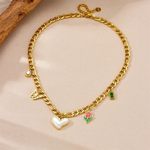 Detailed close-up of gold multi-pendant necklace featuring butterfly and tulip charms